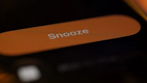 Smartphone alarm screen with snooze button in close up. Concept of oversleeping, Stock Footage 334022909