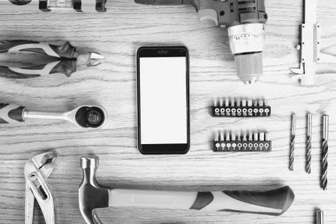 Smartphone and construction tools with blank for sign, top view, flat lay. .. Stock Photos
