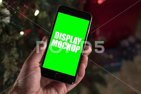 Smartphone and hand with Christmas background template PSD Template