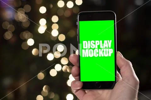 Smartphone and hand with Christmas background template PSD Template
