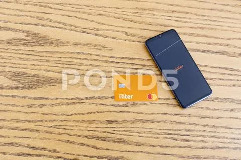Smartphone and inter bank card on the wooden table Stock Photos