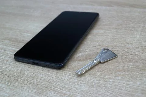 Smartphone and security key, protected access concept Stock Photos