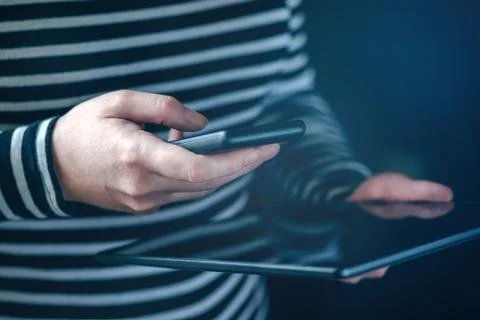 Smartphone and tablet data synchronization, woman syncing files Stock Photos