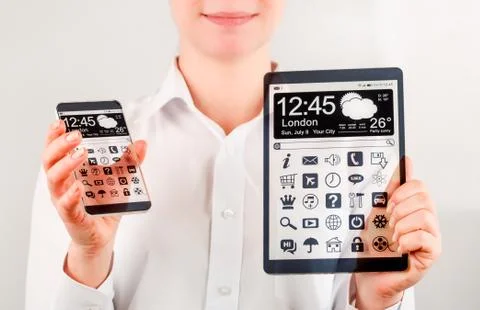 Smartphone and tablet with transparent screen in human hands. 写真素材