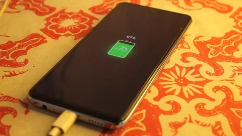 Smartphone battery charging shows 87 percent power Stock Footage 310219967