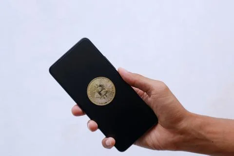Smartphone with bitcoin display on black screen Stock Photos