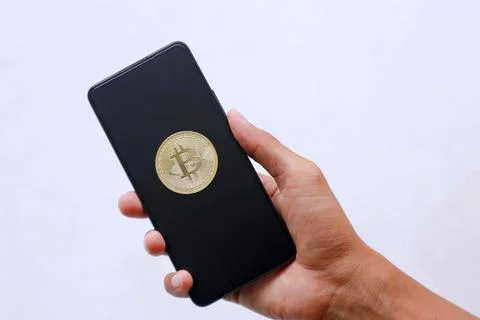 Smartphone with bitcoin display on black screen Stock Photos