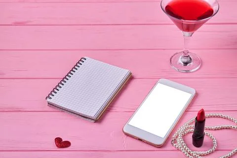 Smartphone with blank screen and notepad for copy space. Stock Photos