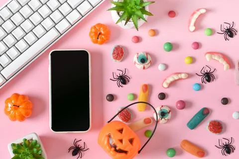 A smartphone with a blank screen on a background of various sweets on a pink  Foto stock