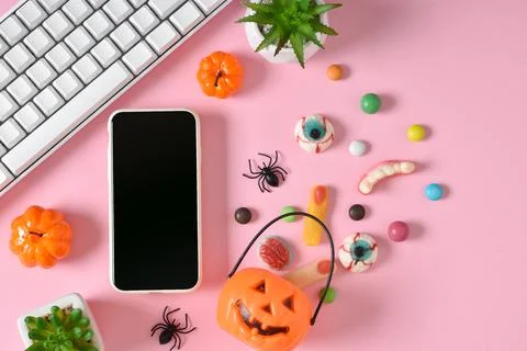A smartphone with a blank screen on a background of various sweets on a pink  Stock Photos