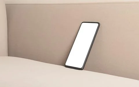 Smartphone with blank screen on a beige sofa. Mobile phone in a minimalist .. Foto stock