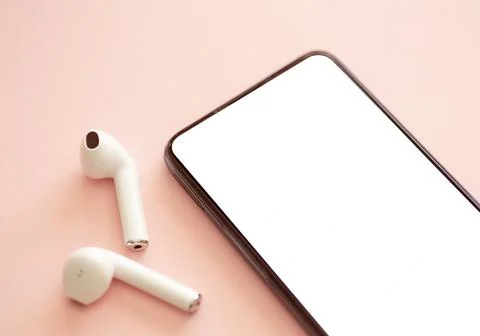 Smartphone blank screen on a colored background with headphones. Stock Photos