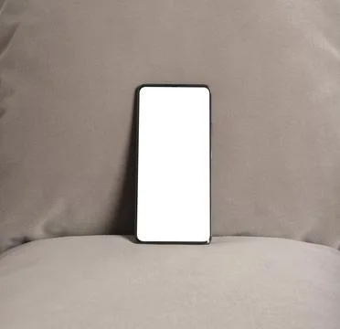 Smartphone with blank screen on a fabric surface. Minimal mobile device moc.. Foto stock