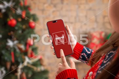 Smartphone with blank screen held forward in Christmas PSD Template