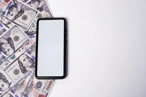 A smartphone with a blank white mockup screen placed vertically over a scat.. Stock Photos