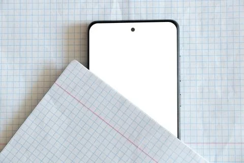 A smartphone with a blank white screen against the background of a grid-lined Stock-Fotos