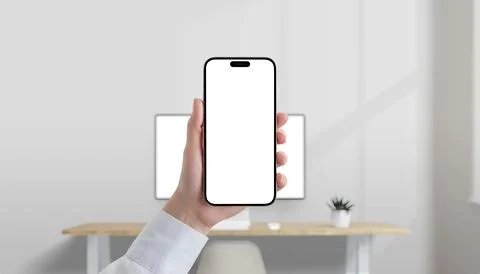 Smartphone with blank white screen held in hand in modern office Stock Photos
