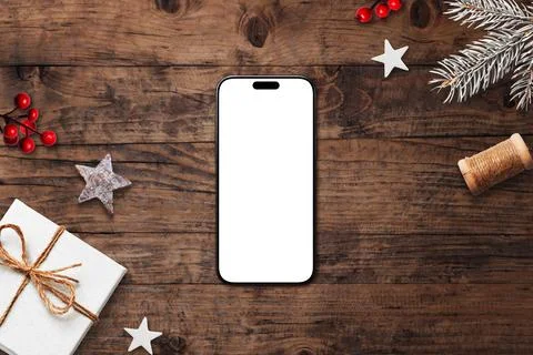 Smartphone with blank white screen on rustic wooden background, surrounded .. Stock Photos