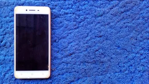 Smartphone on Blue Carpet Stock Photos