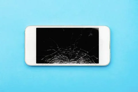 Smartphone with broken screen on blue background Stock Photos