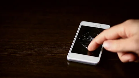 Smartphone with broken screen . A man tries to turn on a broken phone Stock Footage 89081892