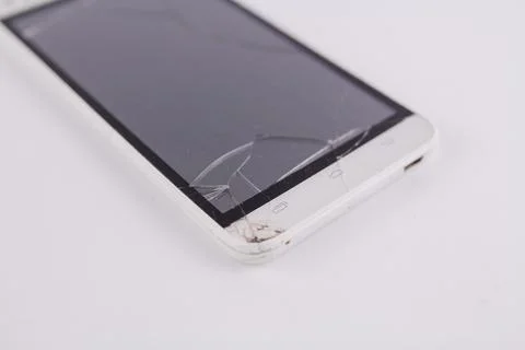 Smartphone with broken screen on white background Stock Photos