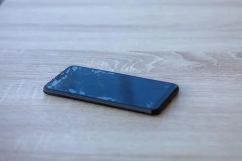 Smartphone with broken touchscreen screen on table desktop Foto stock