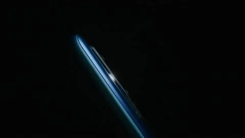 Smartphone camera close-up side plays with light in the dark. Stock Footage 169690029