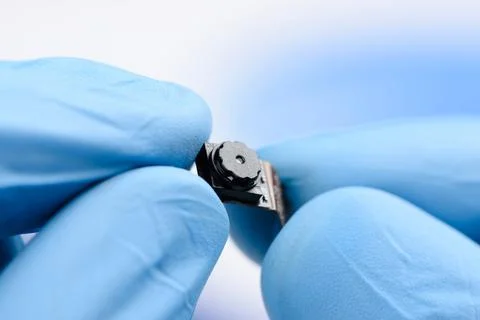 Smartphone camera module in scientist hands. New sensor with high resolution Stock Photos