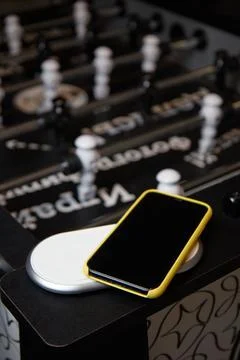 Smartphone case on the table for the board game table football blurred Stock Photos
