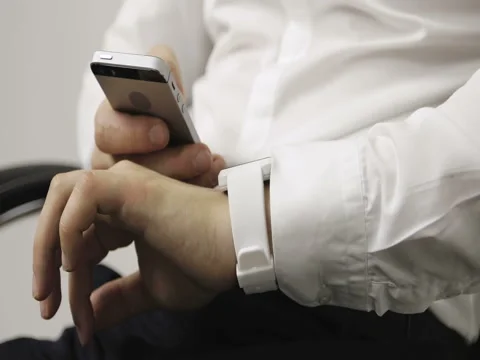 Smartphone cell and a smart watch being connected together and used. Stock Footage 73875783