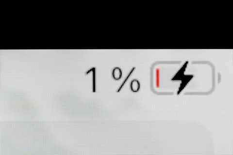 Smartphone charged battery level indicator - one, 1 percent: close up macro Stock Photos