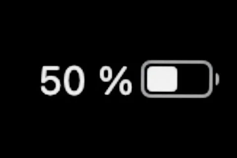 Smartphone charged battery level indicator - fifty, 50 percent: close up macro Stock Photos
