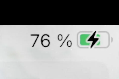 Smartphone charged battery level indicator - 76 percent: close up macro Stock Photos