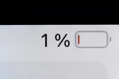 Smartphone charged battery level indicator - one, 1 percent: close up macro Stock Photos