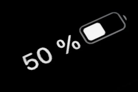 Smartphone charged battery level indicator - fifty, 50 percent: close up macro Stock Photos