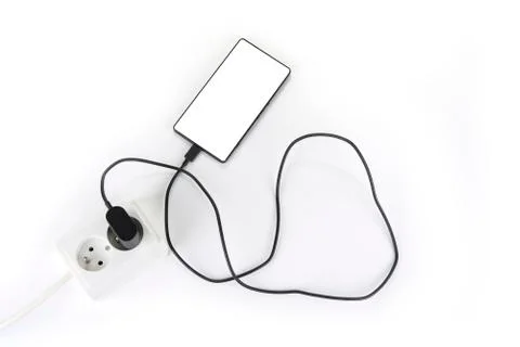 Smartphone charger plug in the socket Stock Photos