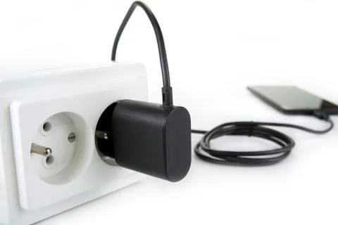 Smartphone charger plug in the socket Stock Photos