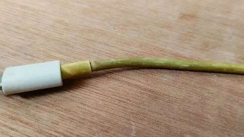 Smartphone charging cable turns yellow on wood texture background 動画素材 296865585