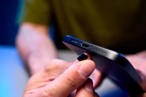 Smartphone charging in a close-up indoor setting with neutral mood and black and Stock Photos