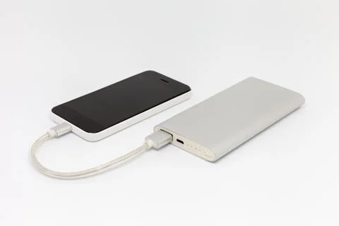 Smartphone is charging from an external battery Stock Photos
