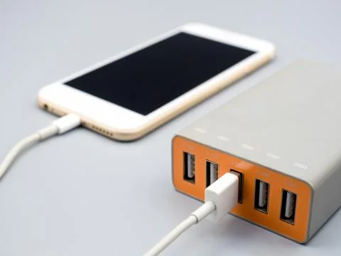 Smartphone charging with multiport USB power adaptor Stock Photos