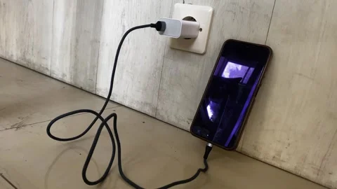 Smartphone Charging on Wall Socket with Cable Plugged In Stock Footage 320128369