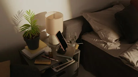 Smartphone Charging on Wireless Charger Stand in Bedroom Stock Footage 337905100