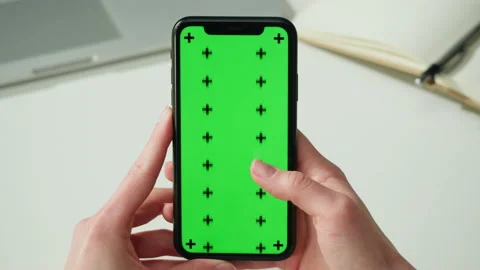 Smartphone with chroma key close-up. Holding mobile phone with green screen Stock Footage 198737289