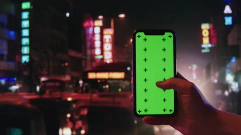 Smartphone with chroma key close-up. Mobile phone with green screen on big city Stock Footage 198733140
