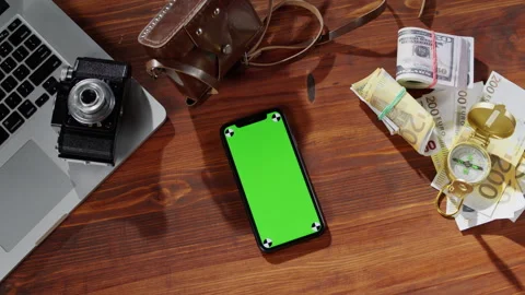 Smartphone with chroma key top view, money cash, compass, photo camera and Stock Footage 168616364