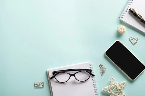 Smartphone, clean blank notepad, glasses, pen, paper clips, pencil on a light Фото