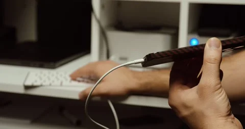 Smartphone Connected to Computer for Backup or Repair – USB Cable Close-Up Stock Footage 331956224