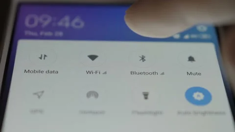 Smartphone connecting to bluetooth. Tablet lying on a table connects to bluet Stock Footage 103797122